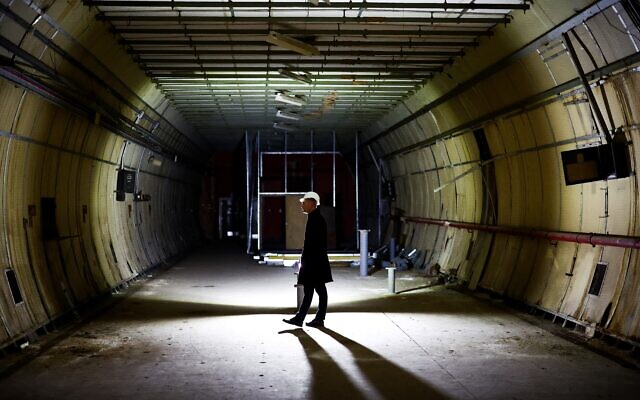 Un journaliste participe à une visite de presse des tunnels souterrains utilisés comme abris pendant le Blitz de la Seconde Guerre mondiale, et développés en une nouvelle attraction touristique appelée "The London Tunnels" à Londres, le 29 janvier 2024. (Crédit : HENRY NICHOLLS / AFP)
