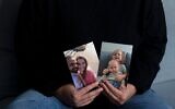 Yifat Zailer montrant des photos de sa cousine, Shiri Bibas et son mari Yarden (à gauche), et de leurs fils Ariel et Kfir, pris en otage par des terroristes du Hamas, à son domicile de Herzliya, en Israël, le 15 janvier 2025. (Crédit : Maya Alleruzzo/AP)