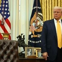 Le président américain Donald Trump derrière son pupitre lors de la cérémonie d'assermentation du secrétaire américain au Commerce Howard Lutnick, dans le Bureau ovale de la Maison Blanche, à Washington, le 21 février 2025. (Crédit : Jim Watson/AFP)