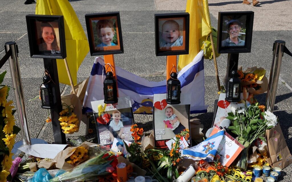 Un mémorial improvisé devant les portraits d'ex-otages israéliens assassinés Shiri (à gauche), Ariel (de gauche à droite) et Kfir (de droite) Bibas, ainsi que d'Oded Lifshitz (à droite) sur la place des otages à Tel-Aviv, le 25 février 2025. (Crédit : Jack Guez / AFP)