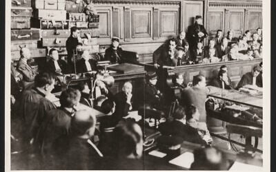 Lors de son procès, docteur Petiot devant l’amoncellement des bagages ayant appartenu à ses victimes.(Crédit : Fonds et collections du Musée et des Archives de la Préfecture)