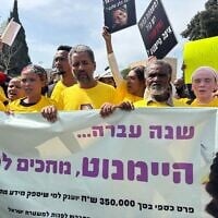 Des manifestants accusant la police de négligence dans l'enquête sur la disparition de Haymanut Kasau, 9 ans, marchent devant la Knesset le 25 mars 2025. (Charlie Summers/Times of Israel)