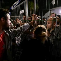 Des personnes protestent contre le Premier ministre Benjamin Netanyahu avant sa visite à une célébration à Moshav Mazor, le 19 avril 2025. (Crédit : Tomer Neuberg/Flash90)