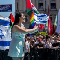 La chanteuse israélienne Yuval Raphael représentant Israël sur le tapis turquoise à côté de l'hôtel de ville de Bâle lors de la cérémonie d'ouverture du Concours Eurovision de la chanson 2025 à Bâle, Suisse, le 11 mai 2025. (Crédit : Fabrice COFFRINI / AFP)