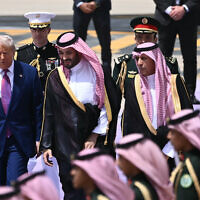 Le prince héritier saoudien Mohammed ben Salmane (au centre) accompagne le président américain Donald Trump (à gauche) à son arrivée à Ryad, le 13 mai 2025. (Crédit : Brendan SMIALOWSKI / AFP)