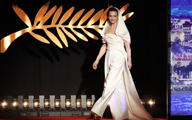 L'actrice française et présidente du jury du 78e Festival de Cannes, Juliette Binoche, arrivant sur scène lors de la cérémonie d'ouverture et de la projection du film « Partir un Jour » (Bye Bye), présenté hors compétition lors de la 78e édition du Festival de Cannes, à Cannes, dans le sud de la France, le 13 mai 2025. (Crédit : Sameer al-Doumy/AFP)