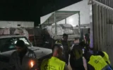 Des camions transportant des produits alimentaires arrivent à un entrepôt du Programme alimentaire mondial à Az-Zawayda, au centre de la bande de Gaza, le 21 mai 2025. (Crédit : AP Photo/Abdel Kareem Hana)