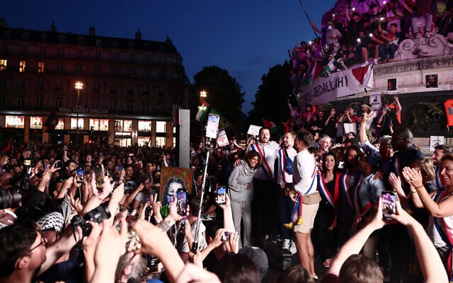 L'eurodéputée du parti LFI, Rima Hassan (à gauche), participant à un rassemblement en sa faveur place de la République à Paris, le 12 juin 2025, après son expulsion suite à son arrestation par Israël avec d'autres militants à bord d'un bateau humanitaire à destination de Gaza. (Crédit : Thibaud Moritz/AFP)