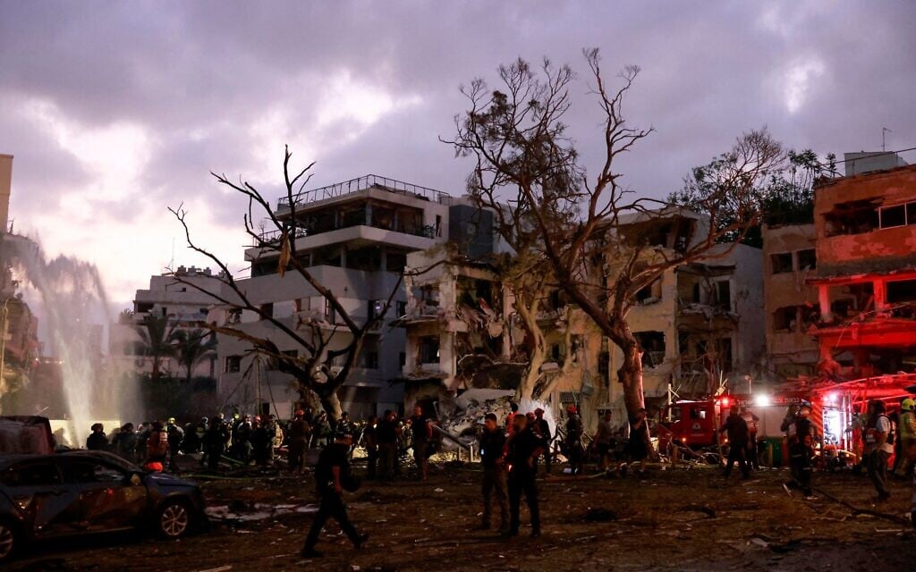 Des secouristes travaillant près des décombres de bâtiments endommagés dans la ville israélienne de Tel Aviv après une nouvelle salve de roquettes iraniennes le 16 juin 2025. (Crédit : Menahem Kahana/AFP)