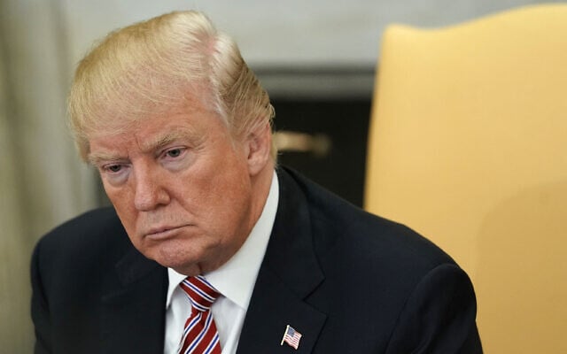 WASHINGTON, DC - FEBRUARY 14: U.S. President Donald Trump listens during a working session regarding the Opportunity Zones provided by tax reform in the Oval Office of the White House February 14, 2018 in Washington, DC. President Trump hosted a group of local elected officials, entrepreneurs, and investors to discuss "how the 'Opportunity Zones' designation in the Tax Cuts and Jobs Act will spur investment and job growth in distressed communities."   Alex Wong/Getty Images/AFP (Photo by ALEX WONG / GETTY IMAGES NORTH AMERICA / Getty Images via AFP)