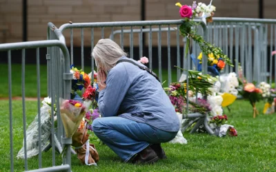 Un visiteur rend hommage aux victimes d'une manifestation de soutien aux otages israéliens détenus dans la bande de Gaza en déposant un bouquet de fleurs devant le palais de justice du comté de Boulder, dans le Colorado, le 3 juin 2025. (Crédit : David Zalubowski/AP)
