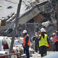 Des équipes israéliennes s'efforçant d'évaluer les dégâts et de déblayer les décombres après qu'une école locale a été la cible d'un tir de missile iranien, à Bnei Brak , le 16 juin 2025. (Crédit : Stav Levaton/Times of Israel)