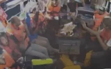 Des militants à bord du Madleen levant les mains dans une vidéo prise le 9 juin 2025. (Crédit : Capture d'écran : Al Jazeera/YouTube)