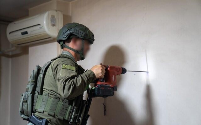 Un soldat de l'armée israélienne mesurant la maison d'un terroriste palestinien, en Cisjordanie, le 11 juillet 2025. (Crédit : Armée israélienne)