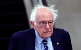 Le sénateur américain Bernie Sanders, du Vermont, marchant vers son bureau, au Capitole, à Washington, le 25 mars 2025. (Crédit : Kevin Dietsch/Getty Images/AFP)