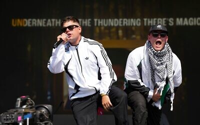 Naoise Ó Cairealláin (à gauche) et Liam Óg, du trio de hip-hop Kneecap, sur scène lors du festival de Glastonbury, le 28 juin 2025. (Crédit : Scott A Garfitt/Invision/AP)