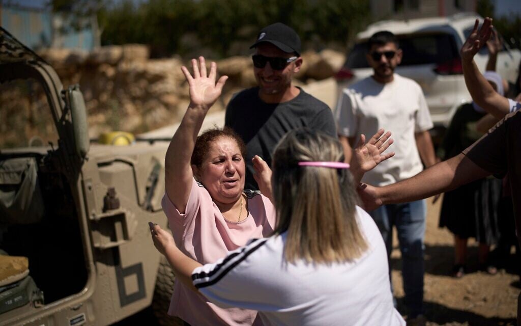 Une femme druze syrienne fait ses adieux à ses parents et amis druzes d'Israël avant de rentrer en Syrie, à la frontière israélo-syrienne, dans la ville de Majdal Shams, sur le plateau du Golan, le 17 juillet 2025. (Crédit : AP Photo/Leo Correa) Une femme druze syrienne fait ses adieux à ses parents et amis druzes d'Israël avant de rentrer en Syrie, à la frontière israélo-syrienne, dans la ville de Majdal Shams, sur le plateau du Golan, le 17 juillet 2025. (Crédit : AP Photo/Leo Correa)