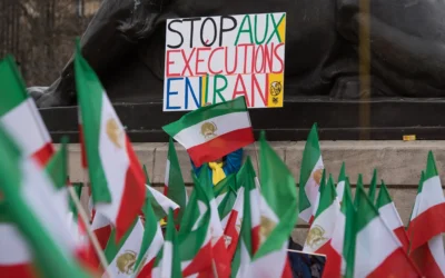 Un manifestant brandit une pancarte sur laquelle on peut lire « Stop aux exécutions en Iran » alors que des manifestants de l'opposition iranienne portent leurs drapeaux nationaux à Paris lors d'un rassemblement pour protester contre la visite du président iranien, Hassan Rouhani, en France, le 28 janvier 2016. (Crédit : AP Photo/Zacharie Scheurer)