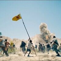Un enfant du pays fictif de Jahranpur brandit un drapeau improvisé de Superman lors d'une attaque des soldats du pays fictif de Boravia, dans "Superman", un film réalisé en 2025 par James Gunn. (Crédit : DC Studios/Warner Bros. via JTA)