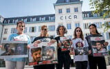 (De gauche à droite) Les proches des otages israéliens détenus par le Hamas à Gaza : Merav Gilboa-Dalal (mère de l'otage Guy Gilboa-Dalal), Silvia Cunio (mère des otages David et Ariel Cunio), Wiki Cohen (mère de l'otage Nimrod Cohen), Galia David (mère de l'otage Evyatar David) et Yeela (sœur de l'otage Evyatar David) posent avec des photos de leurs proches après avoir assisté à une réunion avec le président du Comité international de la Croix-Rouge (CICR) au siège de la Croix-Rouge à Genève, le 12 août 2025. (Crédit : Fabrice COFFRINI / AFP)