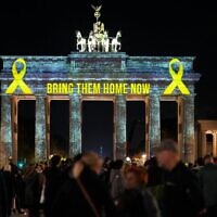La porte de Brandebourg est illuminée en solidarité avec Israël, pour le premier anniversaire du pogrom du Hamas contre Israël, à Berlin, en Allemagne, le lundi 7 octobre 2024. (AP/Markus Schreiber)