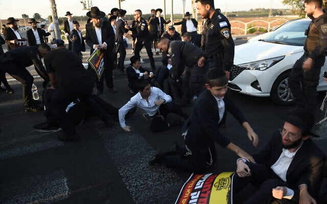 Des manifestants ultra-orthodoxes opposés à l'incarcération d'étudiants de yeshiva n'ayant pas répondu à l'ordre d'enrôlement de l'armée, devant la prison militaire de Beit Lid, près de Kfar Yona, le 20 août 2025. (Crédit : Gili Yaari/Flash90) Des manifestants ultra-orthodoxes opposés à l'incarcération d'étudiants de yeshiva n'ayant pas répondu à l'ordre d'enrôlement de l'armée, devant la prison militaire de Beit Lid, près de Kfar Yona, le 20 août 2025. (Crédit : Gili Yaari/Flash90)