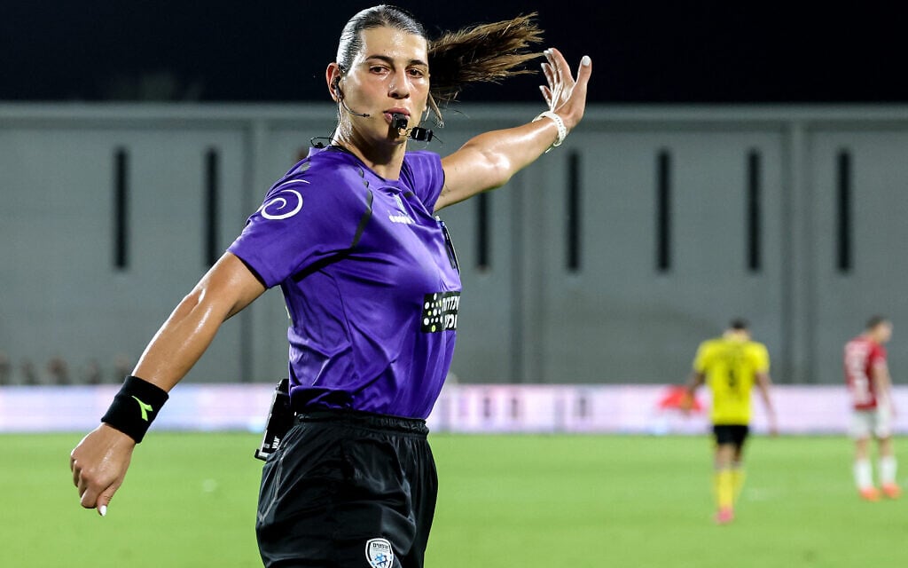 Illustration : L'arbitre israélienne Sapir Berman, 31 ans, première femme transgenre à arbitrer un match de football international, se tient parmi d'autres arbitres et joueurs avant un match de la Premier League israélienne entre le Maccabi Netanya et le Hapoel Beer Sheva, à Netanya, le 24 août 2025. (Crédit : JACK GUEZ / AFP) Illustration : L'arbitre israélienne Sapir Berman, 31 ans, première femme transgenre à arbitrer un match de football international, se tient parmi d'autres arbitres et joueurs avant un match de la Premier League israélienne entre le Maccabi Netanya et le Hapoel Beer Sheva, à Netanya, le 24 août 2025. (Crédit : JACK GUEZ / AFP)