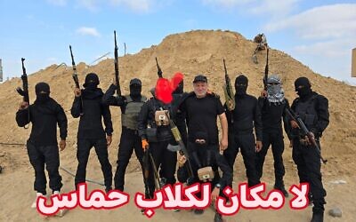 Hossam al-Astal (au centre) est photographié entouré de membres armés de son groupe « Strike Force Against Terror » (Force d'intervention contre le terrorisme) sur une photo non datée prise dans la bande de Gaza. (Crédit : Hossam al-Astal/Facebook)