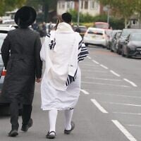 Des Juifs orthodoxes marchant près du lieu d'une attaque terroriste meurtrière à la synagogue Heaton Park Hebrew Congregation, à Crumpsall, Manchester, Angleterre, le 2 octobre 2025. (Crédit : Ian Hodgson/AP)