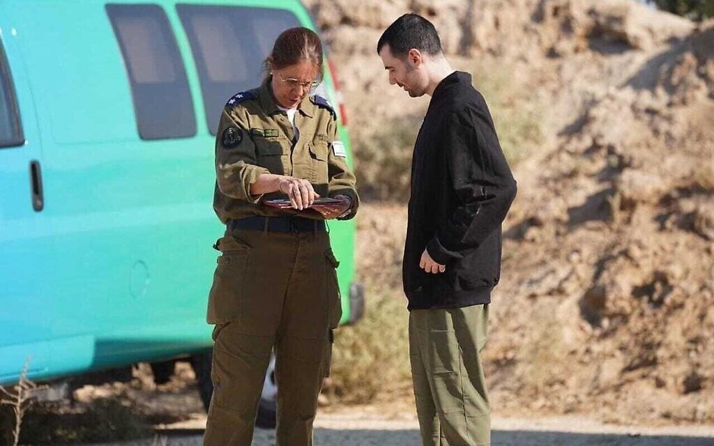L'ex-otage Guy Gilboa-Dalal avec une officiere de l'armée israélienne dans la bande de Gaza peu après avoir été relâché des geôles du Hamas, le 13 octobre 2025. (Crédit : Autorisation)