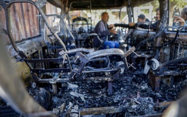 Des Palestiniens inspectant un véhicule incendié lors d'une attaque menée par des résidents d'implantations radicaux, dans le village de Jaba, en Cisjordanie, le 18 novembre 2025. (Crédit : Flash90)