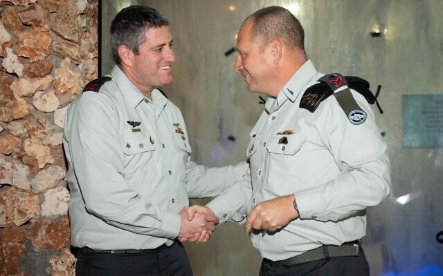 Le chef du Commandement des Forces terrestres, le général de division Nadav Lotan (à droite), serrant la main du nouveau chef d'état-major du Commandement des Forces terrestres, le général de brigade Yaïr Natans, lors d'une cérémonie de passation de pouvoir pour le chef du Corps d'artillerie, à Zichron Yaakov, le 25 novembre 2025. (Crédit : Armée israélienne)