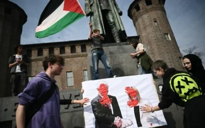 Des étudiants brandissent des portraits de la Première ministre italienne Giorgia Meloni serrant la main du Premier ministre israélien Benjamin Netanyahu, avec des mains rouges peintes sur le visage, lors d'une manifestation contre le gouvernement italien à Turin, dans le nord-ouest de l'Italie, le 22 mars 2024. (Crédit : MARCO BERTORELLO / AFP)