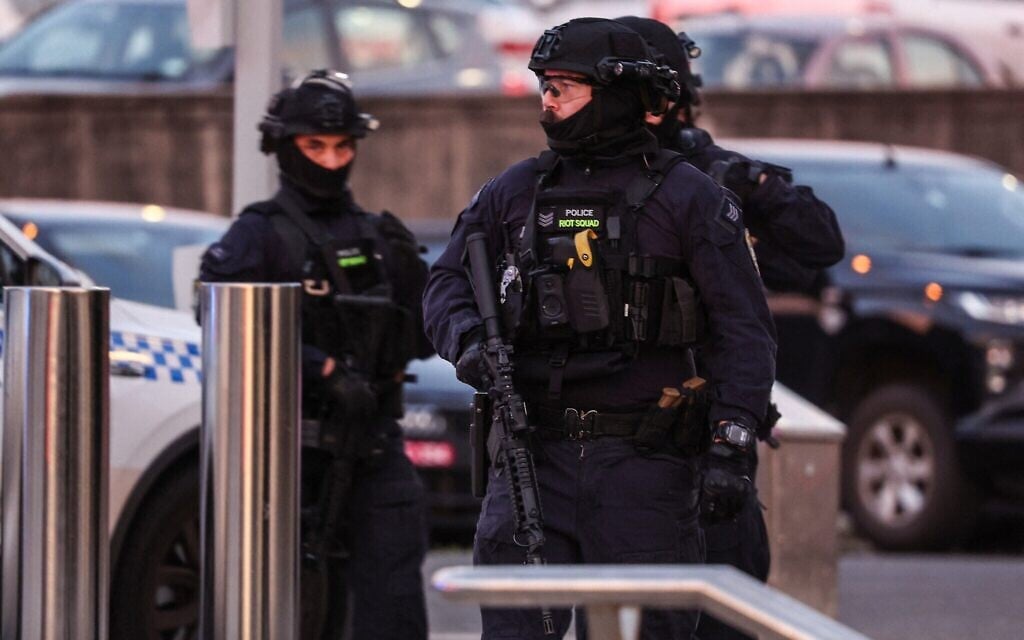 Des policiers armés intervenant sur les lieux après une fusillade lors d'un événement célébrant Hanoukka, à Bondi Beach, à Sydney, le 14 décembre 2025. (Crédit : David Gray/AFP)