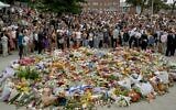 Des personnes en deuil rassemblées autour d'hommages floraux au Bondi Pavilion en mémoire des victimes d'une fusillade terroriste à Bondi Beach, à Sydney, le 15 décembre 2025. (Crédit : Saeed Khan/AFP)