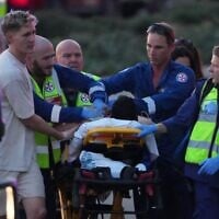 Un blessé sur une civière après une fusillade lors d'un événement de Hanoukka, à Bondi Beach, à Sydney, le 14 décembre 2025. (Crédit : Mark Baker/AP Photo)