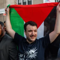L'activiste américain anti-israélien et pro-palestinien Mahmoud Khalil brandit un drapeau palestinien lors d'un rassemblement célébrant son retour après avoir été détenu dans un centre de rétention pour immigrants, le 22 juin 2025, à New York. (Crédit : AP Photo/Olga Fedorova)