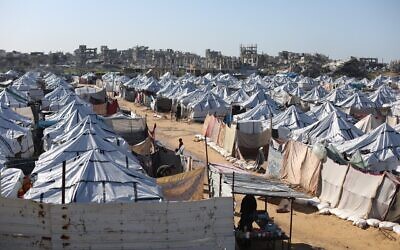 Des Gazaouis déplacés près de leurs tentes à Gaza-City, le 11 janvier 2026. (Crédit : Ali Hassan/Flash90)