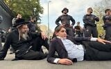Des hommes haredim bloquent la route devant le centre de recrutement de l'armée israélienne à Jérusalem, le 12 novembre 2025. (Crédit : Sam Sokol/Times of Israel)