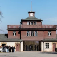 Des visiteurs faisant la queue devant l'entrée principale du mémorial de l'ancien camp de concentration nazi de Buchenwald, le 3 avril 2025. (Crédit : Jens Schlueter/AFP)