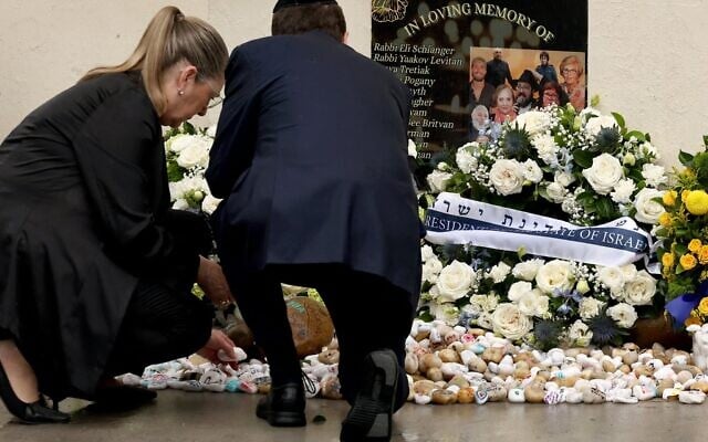 Le président Isaac Herzog (à droite) et son épouse Michal déposant des pierres de Jérusalem en hommage aux victimes de la tuerie antisémite du 14 décembre 2025 au Bondi Pavilion, à Sydney, le 9 février 2026. (Crédit : David Gray/AFP)