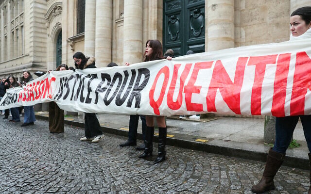 Des manifestants se tiennent derrière une banderole sur laquelle on peut lire "Antifa assassins, justice pour Quentin" lors d'un rassemblement organisé à Paris le 15 février 2026, après le passage à tabac mortel de Quentin, un jeune homme de 23 ans, à Lyon. (Crédit: ALAIN JOCARD / AFP)