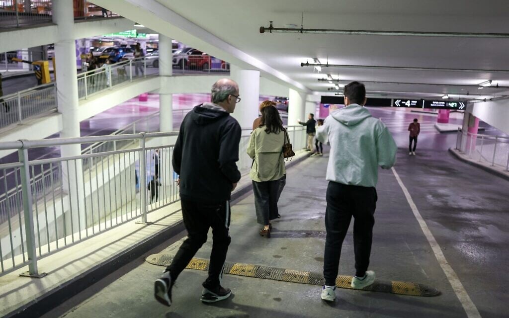 Des personnes se réfugiant dans un parking après le déclenchement des sirènes à Tel Aviv le 28 février 2026, à la suite de l'annonce du lancement d'une frappe préventive contre l'Iran par Israël. (Crédit : Ilia Yefimovich/AFP)