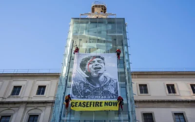 Des activistes de Greenpeace accrochent une illustration de l’artiste américain Shepard Fairey intitulée « Obey » à l’extérieur du musée Reina Sofia, avec une image prise par le photojournaliste gazaoui Belal Khaled, qui montre un enfant palestinien appelant à l’aide, Madrid, Espagne, 24 janvier 2024. (Crédit : Bernat Armangue/AP)