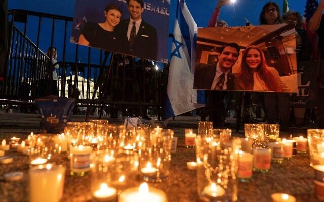Des personnes réunies pour allumer des bougies dans un mémorial improvisé en hommage à Yaron Lischinsky et Sarah Milgrim, deux employés de l'ambassade d'Israël tués alors qu'ils quittaient une manifestation au Capital Jewish Museum de Washington, lors d'une veillée aux chandelles devant la Maison Blanche, à Washington, le 22 mai 2025. (Crédit : Jose Luis Magana/AP Des personnes réunies pour allumer des bougies dans un mémorial improvisé en hommage à Yaron Lischinsky et Sarah Milgrim, deux employés de l'ambassade d'Israël tués alors qu'ils quittaient une manifestation au Capital Jewish Museum de Washington, lors d'une veillée aux chandelles devant la Maison Blanche, à Washington, le 22 mai 2025. (Crédit : Jose Luis Magana/AP