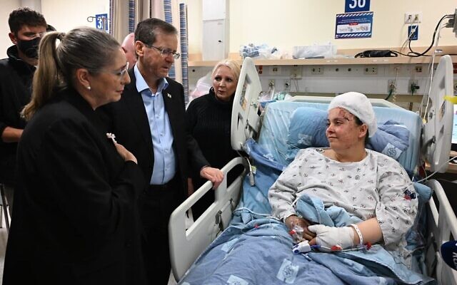 Cette photo montre le président Isaac Herzog et son épouse Michal rendant visite à Penina Cohen, blessée par un missile iranien, à l'hôpital Hadassah de Jérusalem, le 2 mars 2026. (Crédit : Haim Zach/GPO)