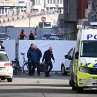 La police belge enquêtant devant une synagogue touchée par une explosion dans la nuit, à Liège, en Belgique, le 9 mars 2026. (Crédit : John Thys/AFP)