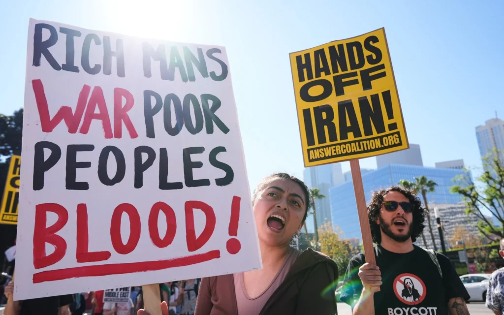 Des manifestants protestent contre les frappes américaines et israéliennes sur l’Iran le 28 février 2026 à Los Angeles. (Crédit : Damian Dovarganes/AP)