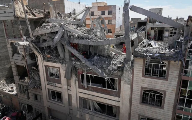 Les secours inspectent un bâtiment touché par une frappe américano-israélienne à Téhéran, en Iran, le 27 mars 2026. (Crédit : AP Photo/Vahid Salemi)