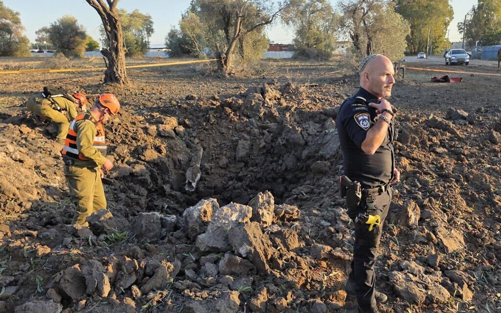 Le site d'impact d'un missile du groupe terroriste chiite libanais du Hezbollah dans une zone dégagée du centre d'Israël, le 9 mars 2026. (Crédit : Police israélienne)
